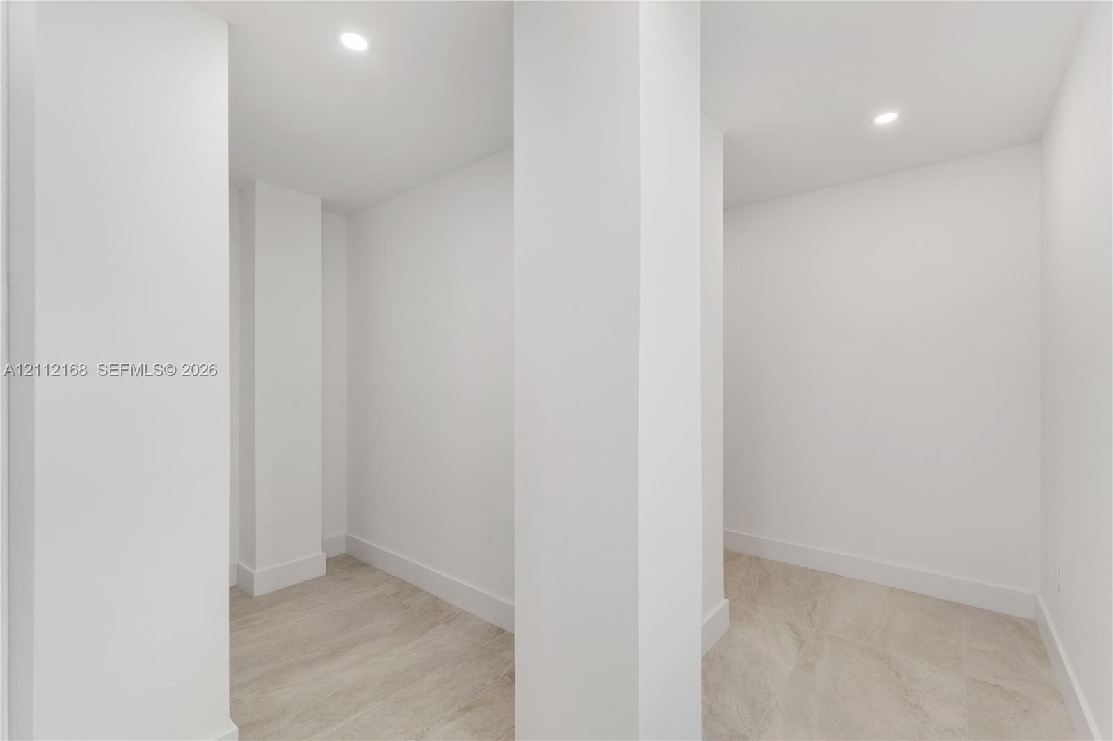 Interior space featuring neutral wall tones, recessed lighting, and wood-finish flooring