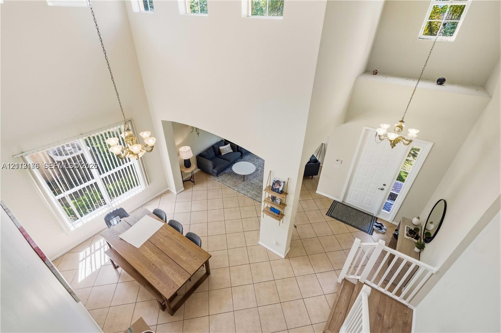 Double-height ceilings, ceramic tile flooring, arched wall openings, multi-tier windows, and traditional multi-arm chandeliers Double-height ceilings, ceramic tile flooring, arched wall openings, multi-tier windows, and traditional multi-arm chandeliers