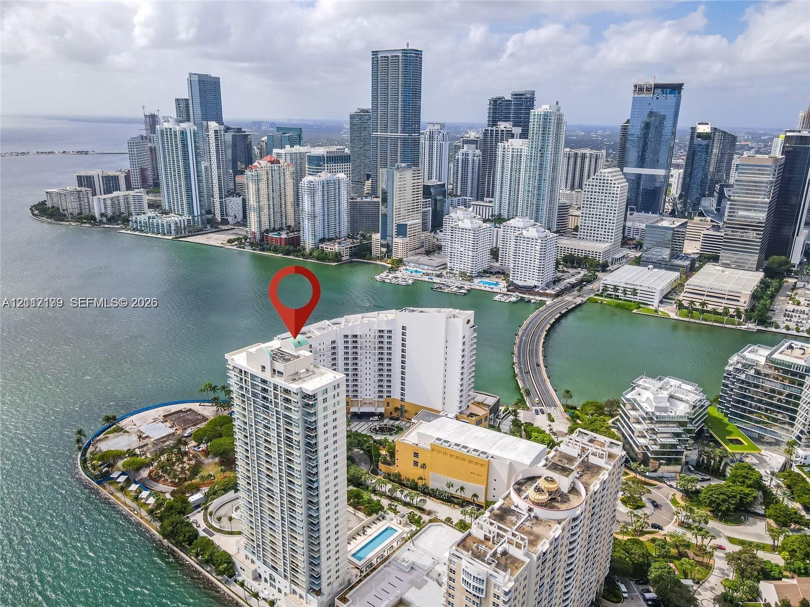 Aerial perspective of waterfront high-rise featuring a coastal location, immediate proximity to Biscayne Bay, and panoramic urban skyline exposure