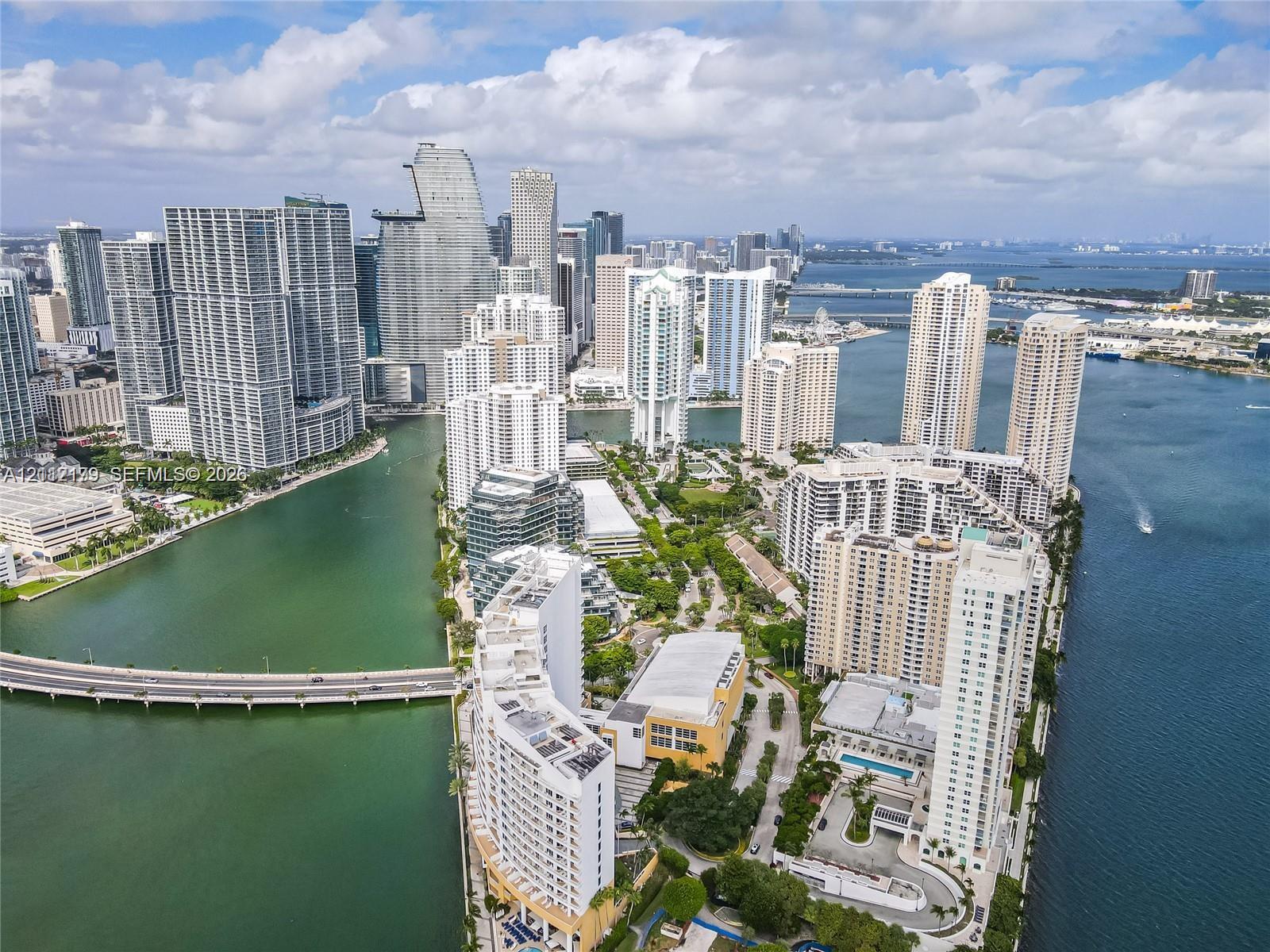 Aerial perspective featuring high-density urban infrastructure, coastal waterway access, and proximity to metropolitan skylines