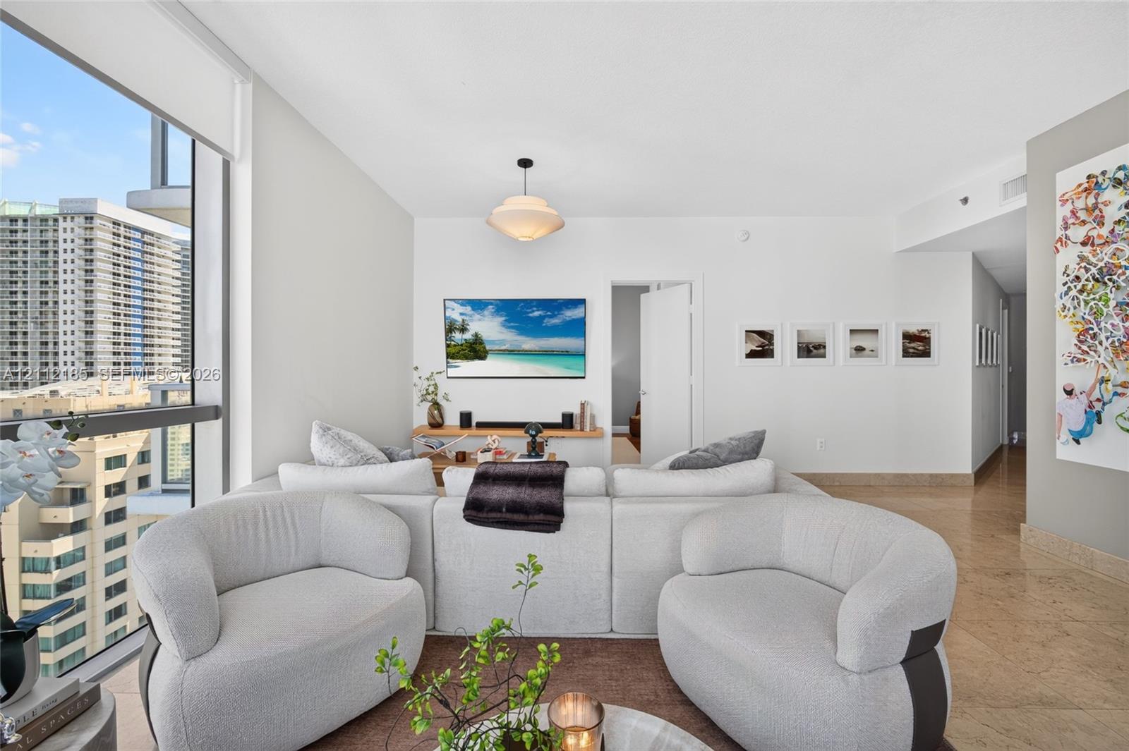 Floor-to-ceiling windows, polished stone flooring, recessed lighting, and a neutral color palette