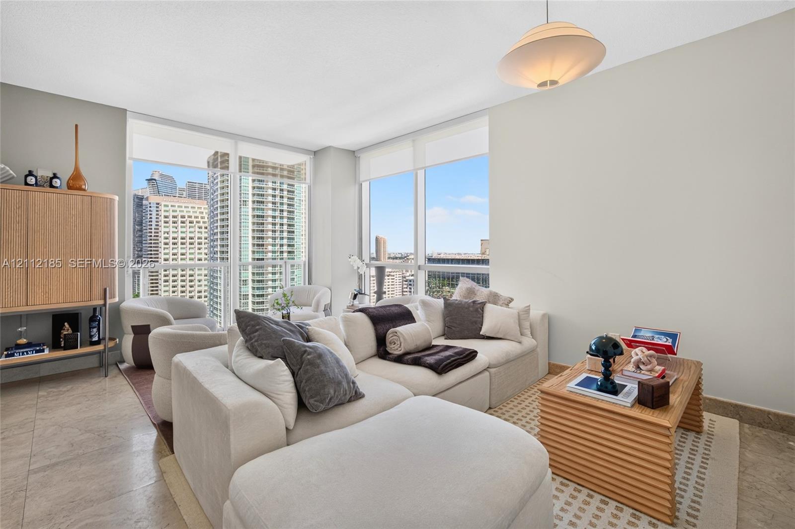 Floor-to-ceiling windows, stone-finish flooring, and recessed lighting fixture