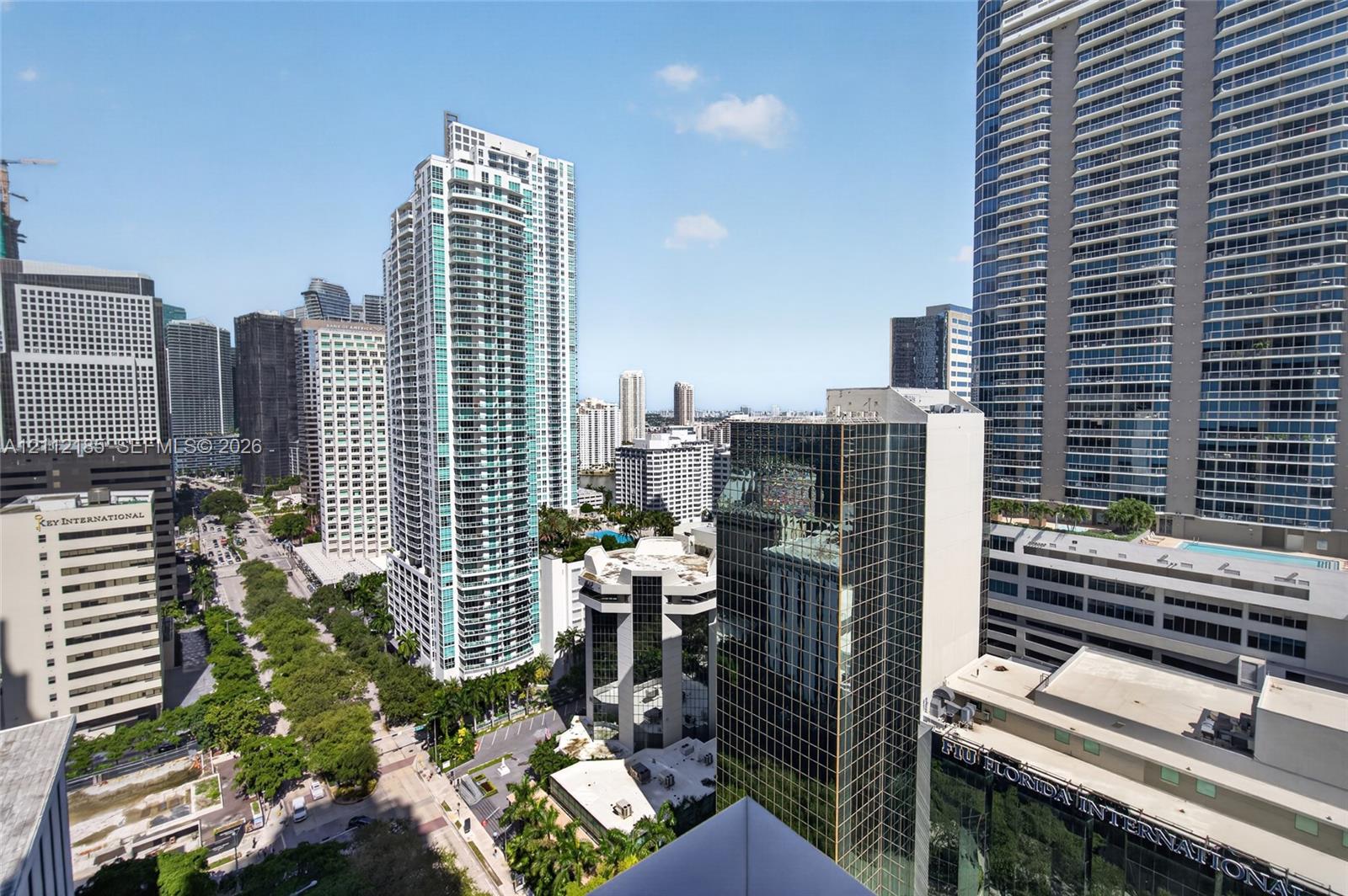 Urban skyline panorama featuring multi-story glass-facade skyscrapers, high-density metropolitan infrastructure, and established tree-lined boulevards
