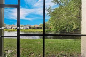 Screened enclosure featuring water frontage and mature landscaping