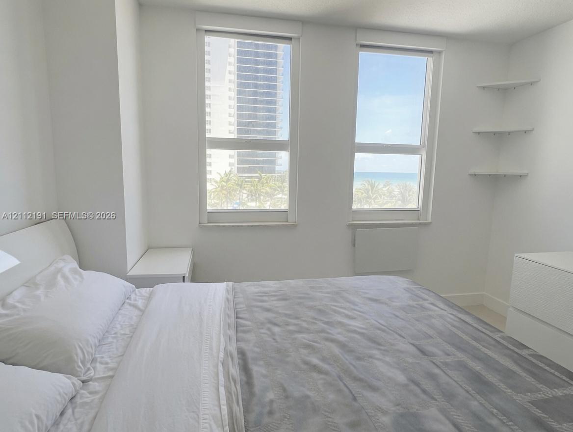 Dual vertical windows featuring built-in corner shelving and neutral wall finishes Dual vertical windows featuring built-in corner shelving and neutral wall finishes