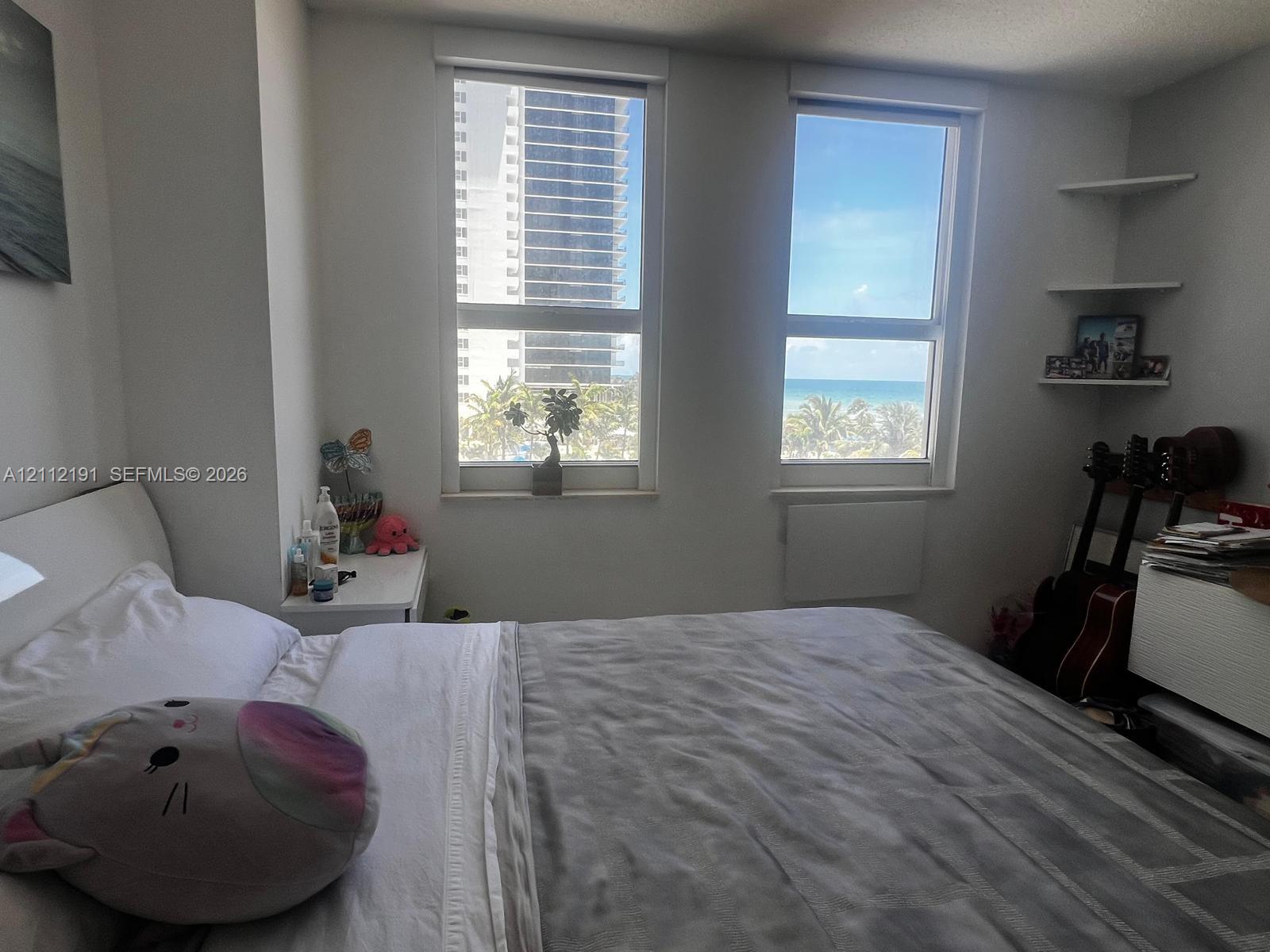Dual vertical windows, built-in wall shelving, and water horizon backdrop Dual vertical windows, built-in wall shelving, and water horizon backdrop
