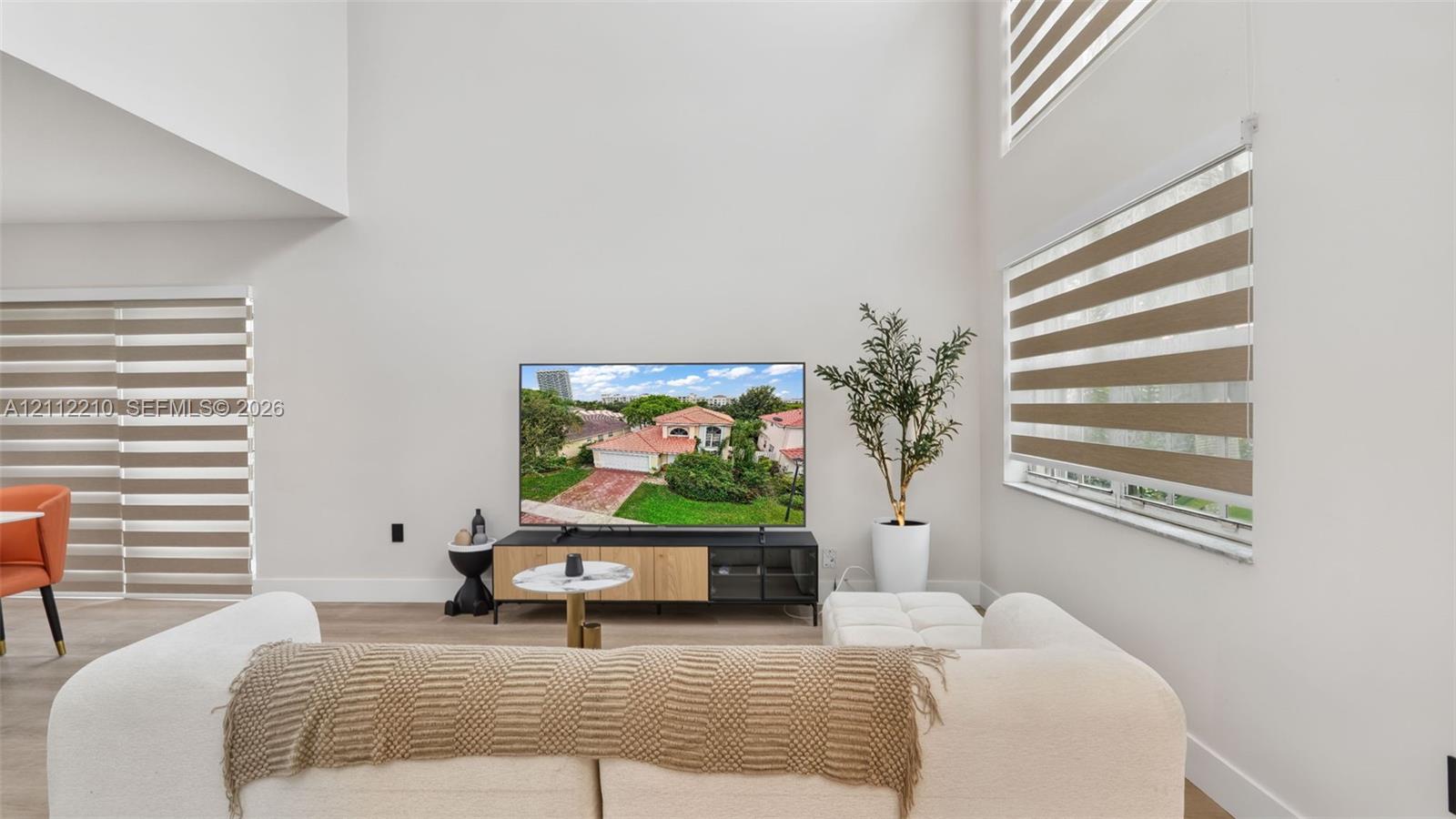 Double-height ceilings, expansive wall space, and tiered roller window shades