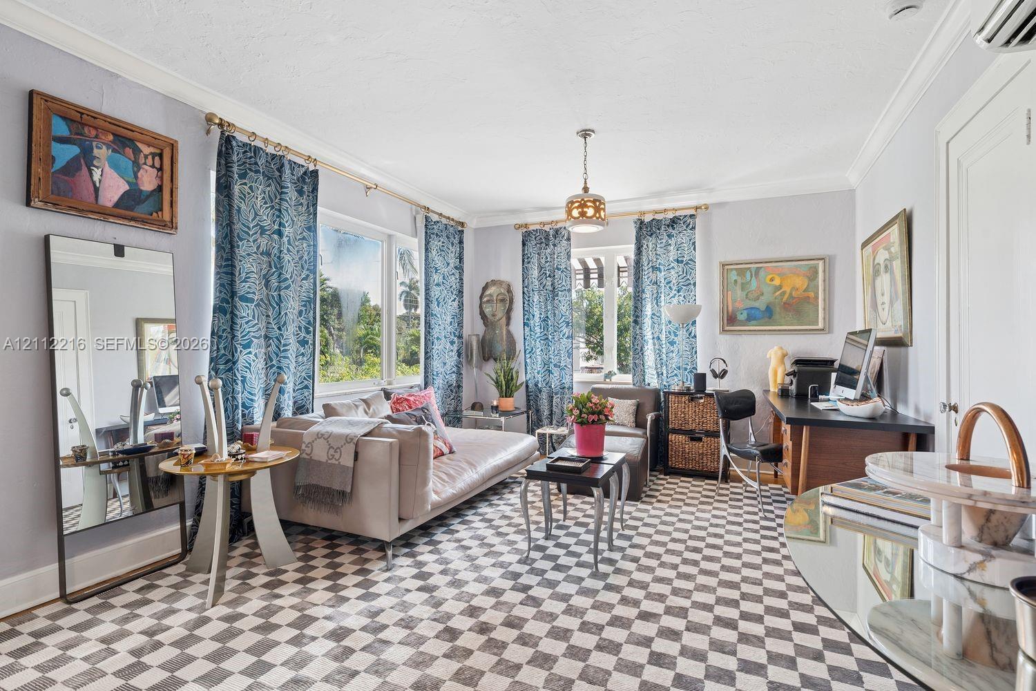 Living space featuring crown molding, multiple windows with decorative brass curtain rods, checkered tile flooring, and a central pendant light fixture