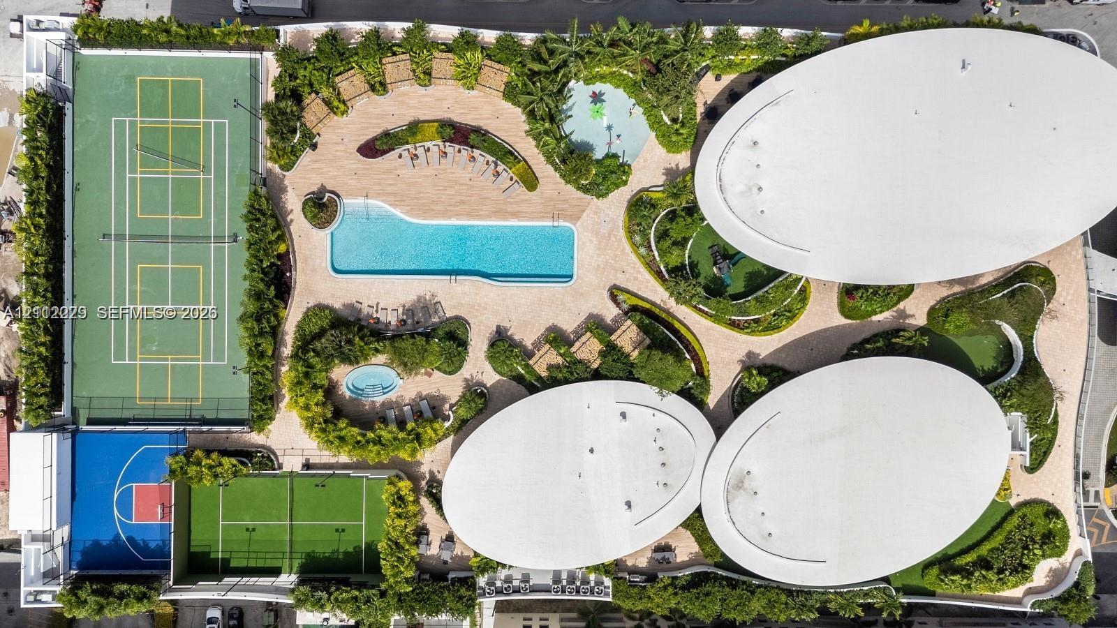 Recreational grounds featuring a tennis court, basketball court, swimming pool, spa, and structured shade canopies