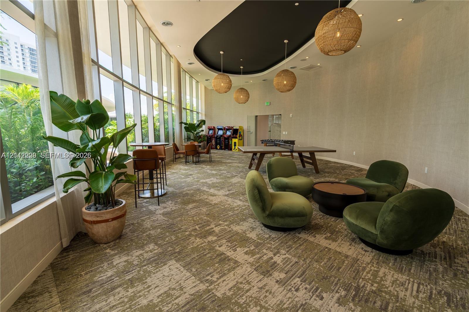 Floor-to-ceiling windows, recessed lighting, textured wall coverings, multi-level ceiling design, and woven pendant fixtures