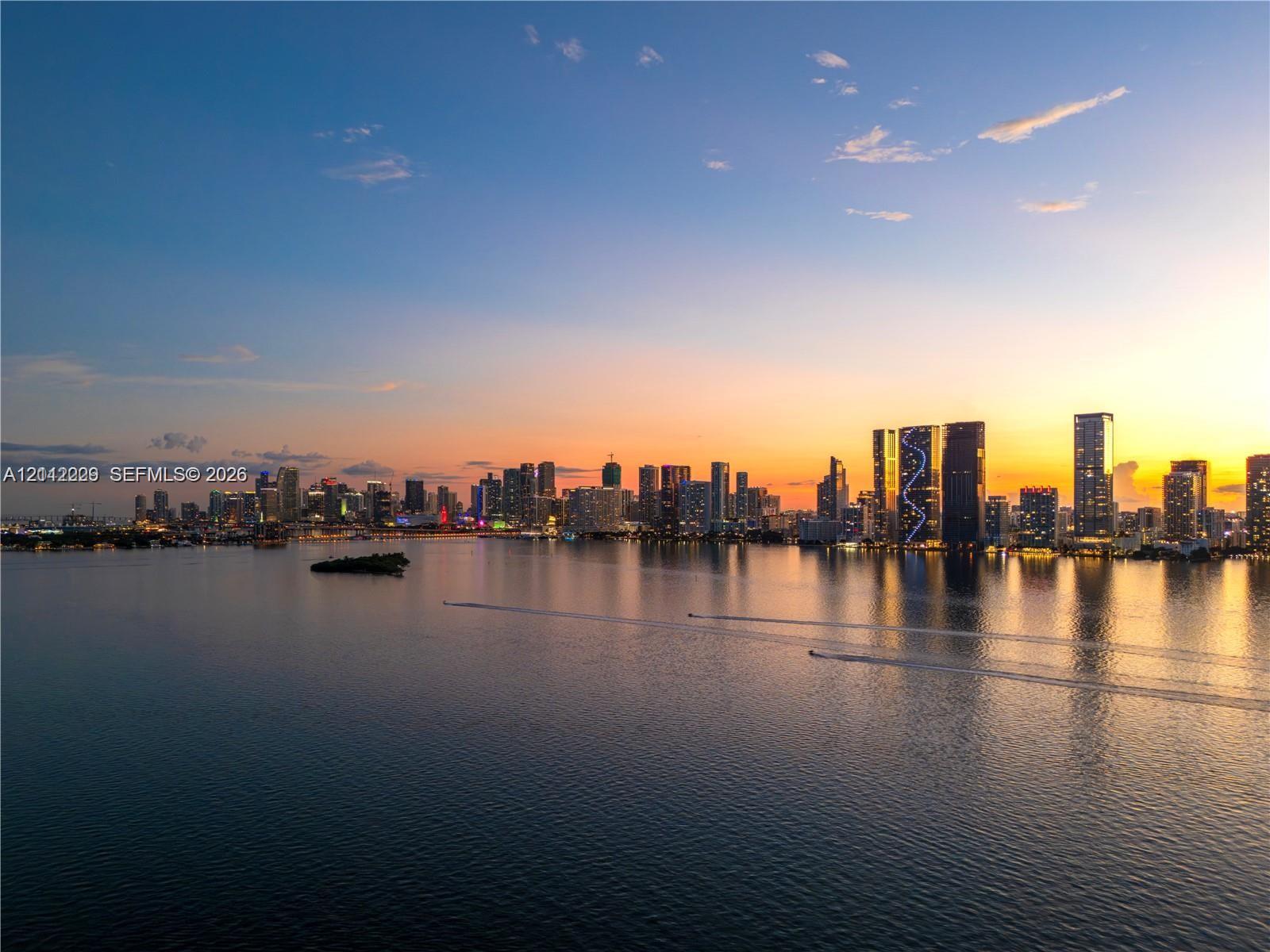 Panoramic water expanse showcasing a multifaceted city skyline at dusk