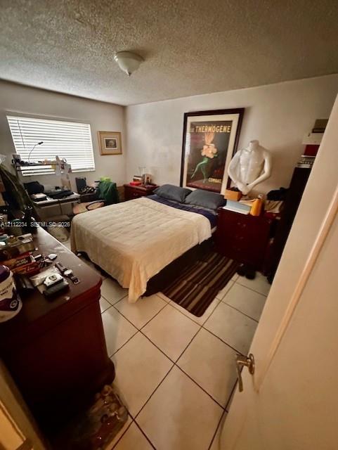 Neutral-toned ceramic tile flooring, horizontal window blinds, and a flush-mount ceiling light fixture