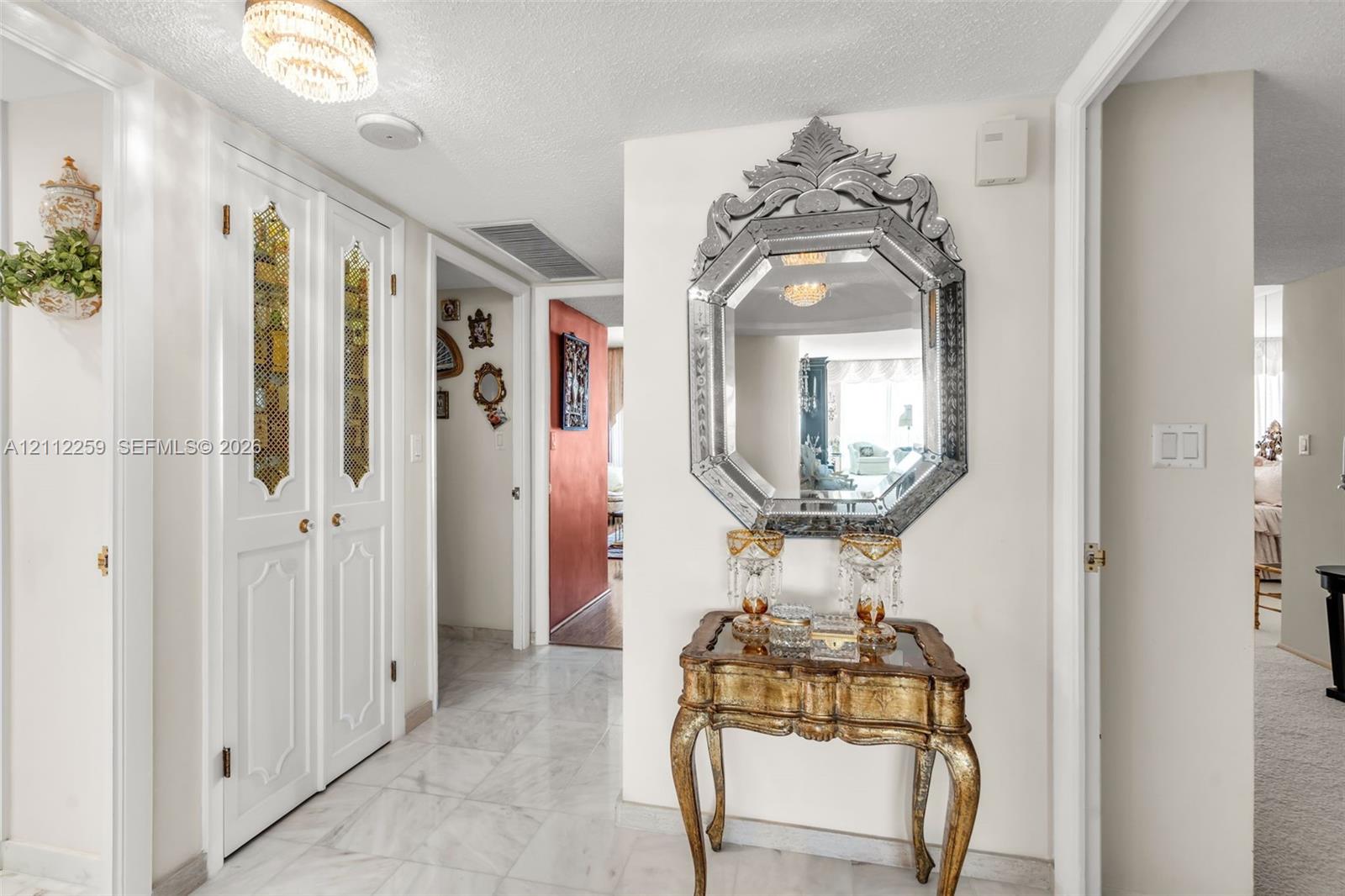 Foyer featuring stone-finish tile flooring, recessed ceiling lighting, and double-panel doors with decorative glass inserts