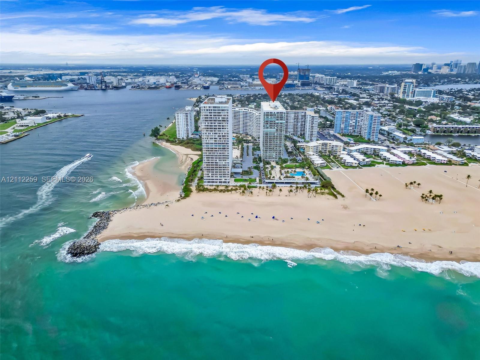 High-rise building featuring direct oceanfront access, private swimming pool, landscaped grounds, and proximity to the coastline High-rise building featuring direct oceanfront access, private swimming pool, landscaped grounds, and proximity to the coastline