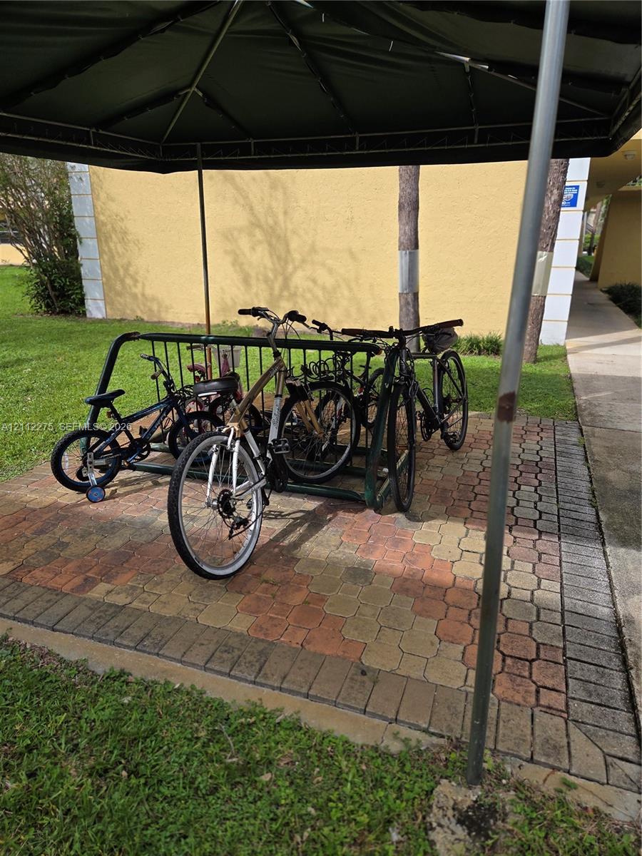 Covered outdoor bike rack set on a multi-tonal paver foundation