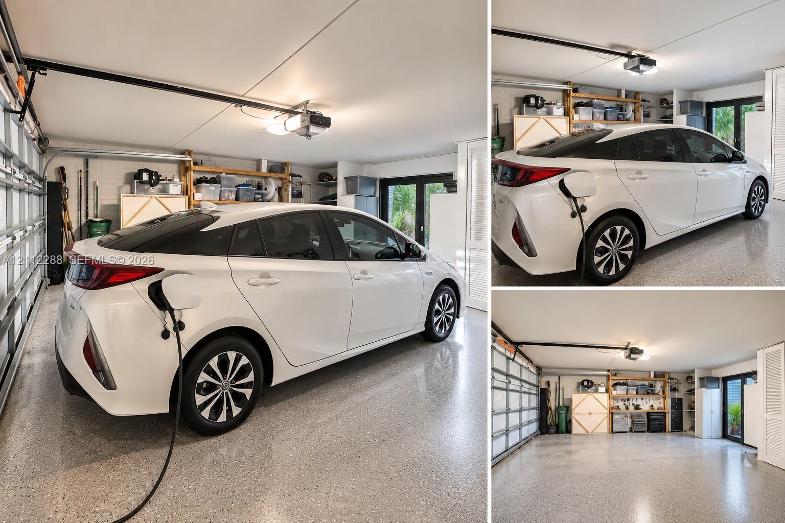 Multi-car garage featuring epoxy flooring, electric vehicle charging station, and glass-paned exterior doors