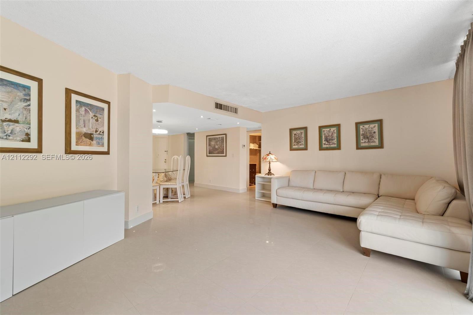 Open-concept interior featuring large-format tile flooring, smooth ceiling finishes, and recessed lighting Open-concept interior featuring large-format tile flooring, smooth ceiling finishes, and recessed lighting
