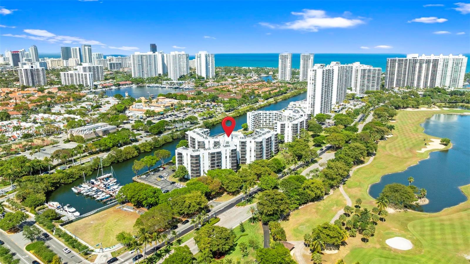 Mid-rise residential building situated on a waterfront lot featuring marina access and proximity to local golf course grounds Mid-rise residential building situated on a waterfront lot featuring marina access and proximity to local golf course grounds
