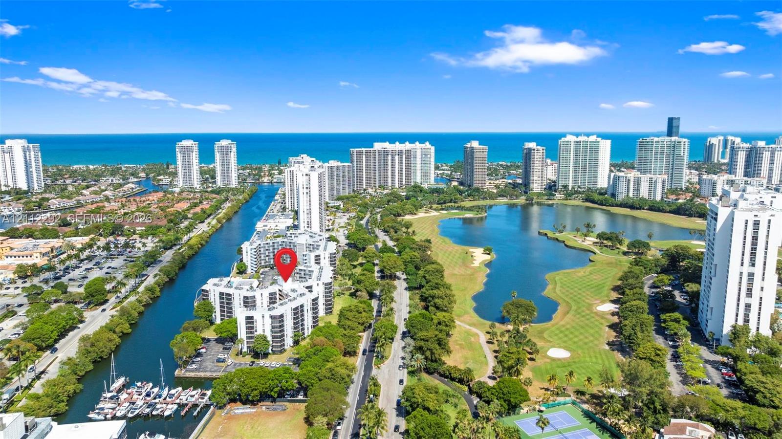 Aerial perspective featuring proximity to the Atlantic coastline, waterfront canal access, boat slips, and an expansive golf course Aerial perspective featuring proximity to the Atlantic coastline, waterfront canal access, boat slips, and an expansive golf course