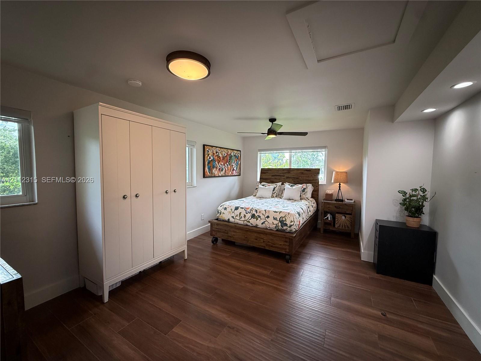 Wood-finish flooring, recessed lighting, ceiling fan, and multi-paned windows