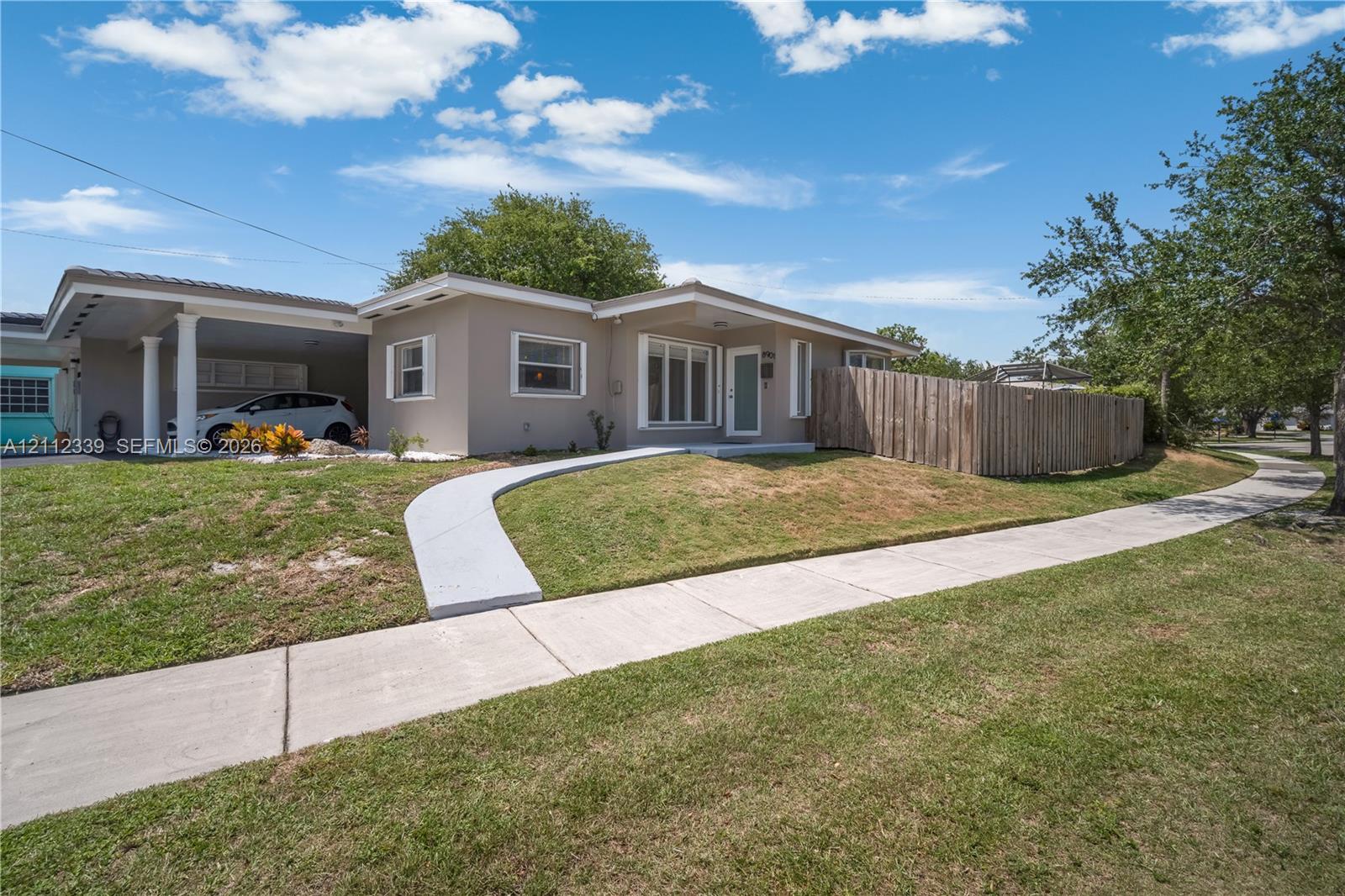 Single-story duplex featuring a concrete walkway, and wood privacy fencing for your private back yard