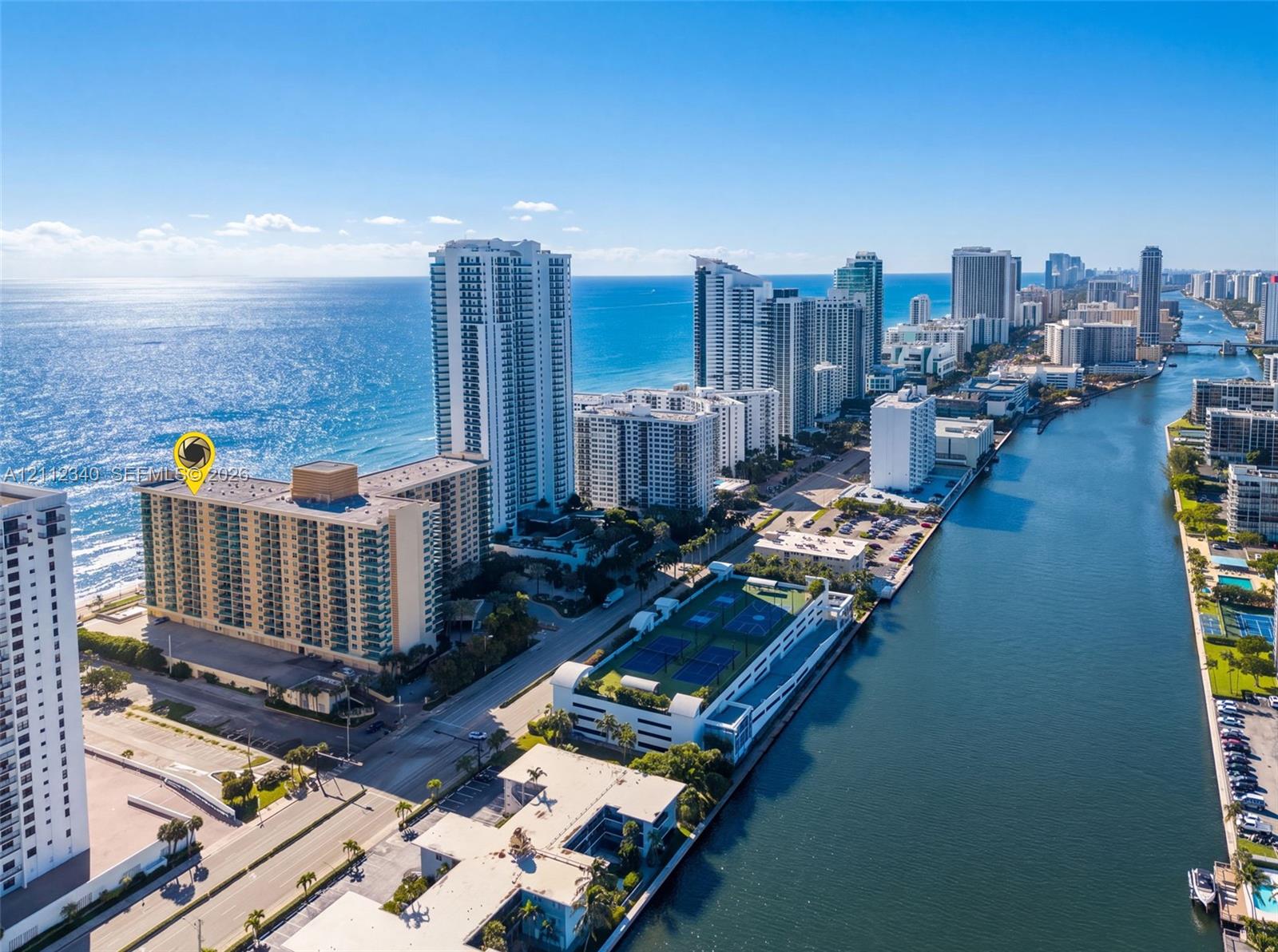 High-rise residential building featuring expansive oceanfront positioning, balcony access, and proximity to coastal waterways High-rise residential building featuring expansive oceanfront positioning, balcony access, and proximity to coastal waterways