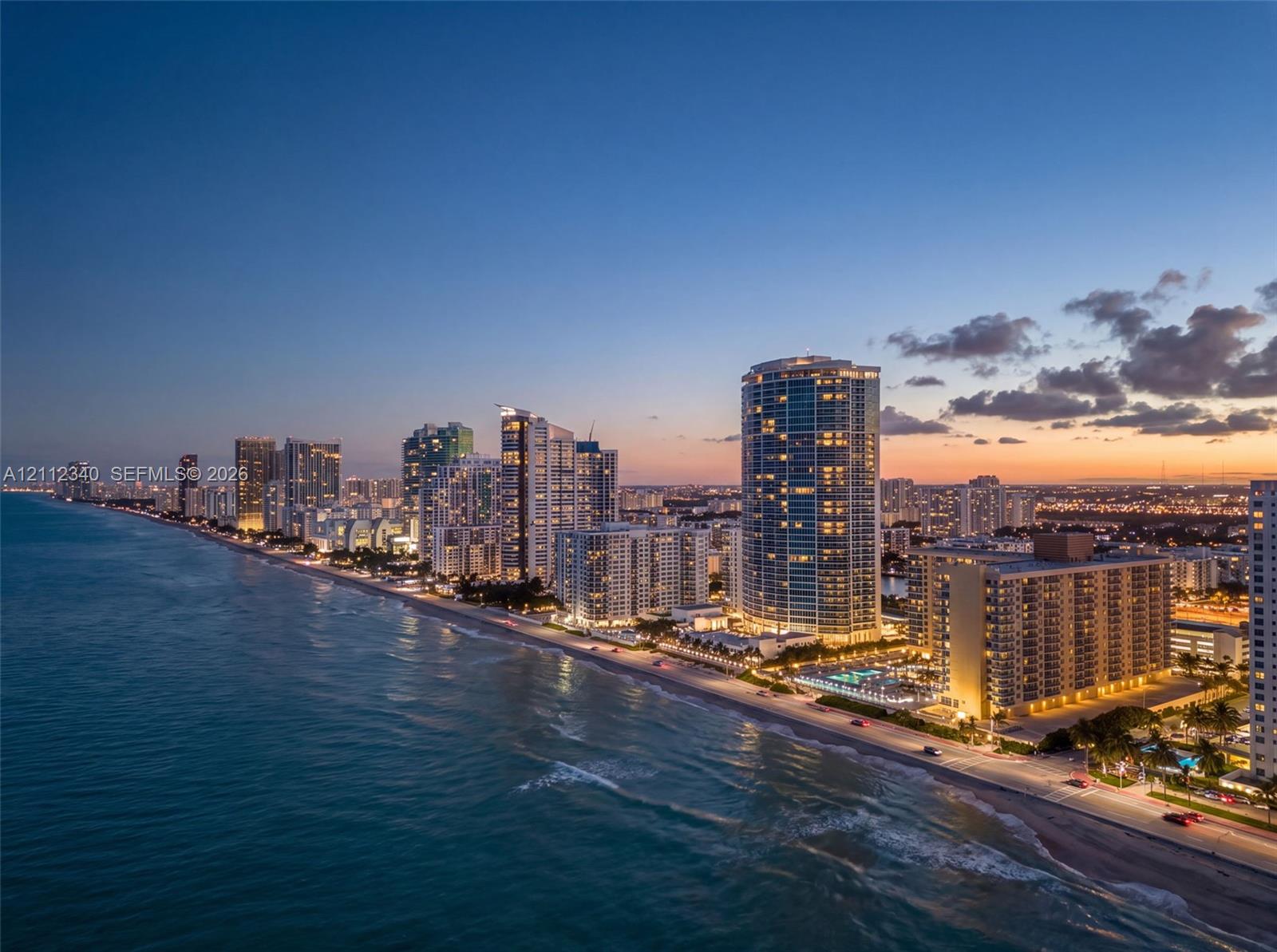 Coastal high-rise buildings situated directly along the shoreline with sandy beach access and expansive ocean horizons Coastal high-rise buildings situated directly along the shoreline with sandy beach access and expansive ocean horizons