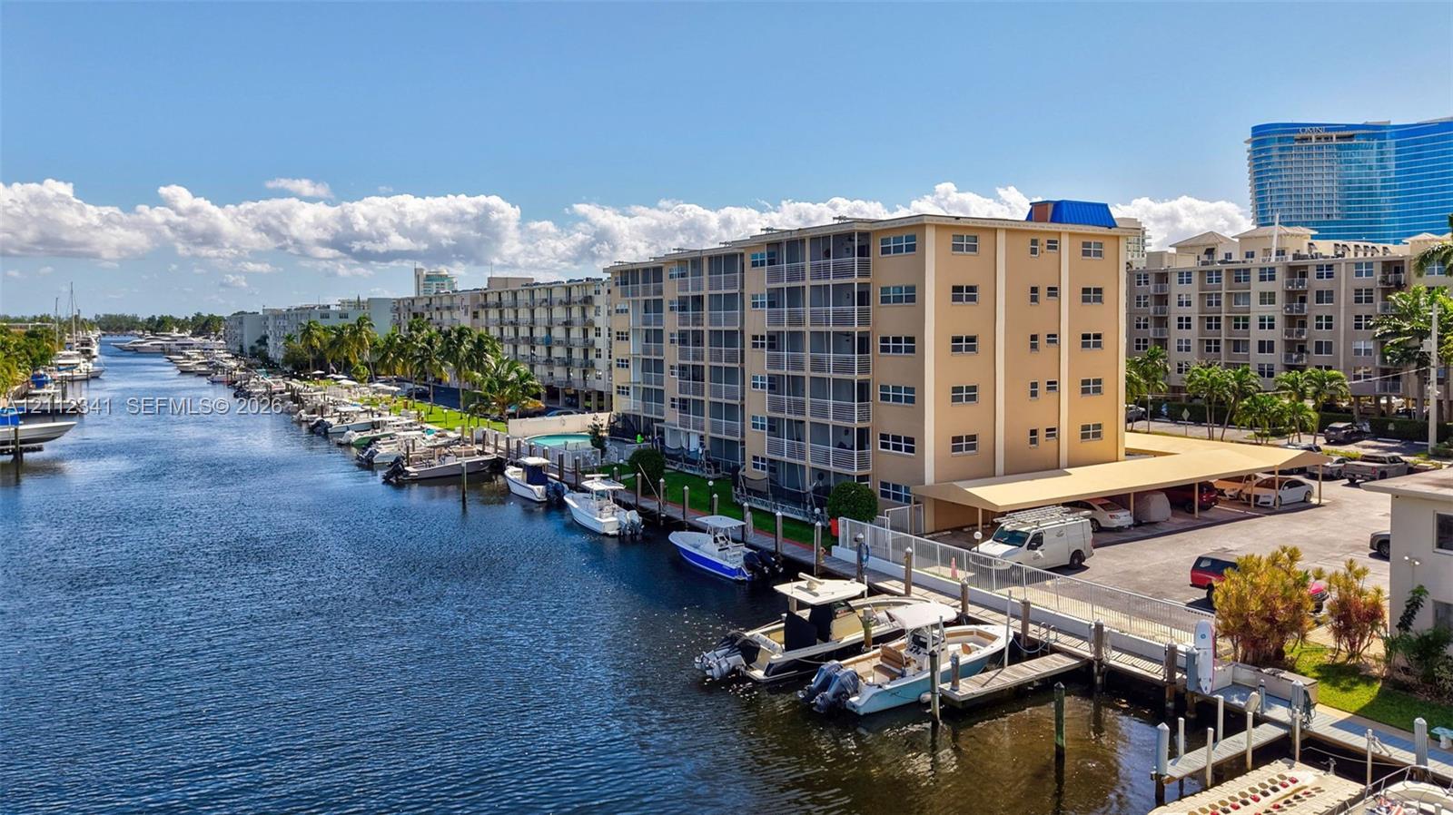 Waterfront multi-story residential building featuring private boat slips, covered parking, and screened balconies