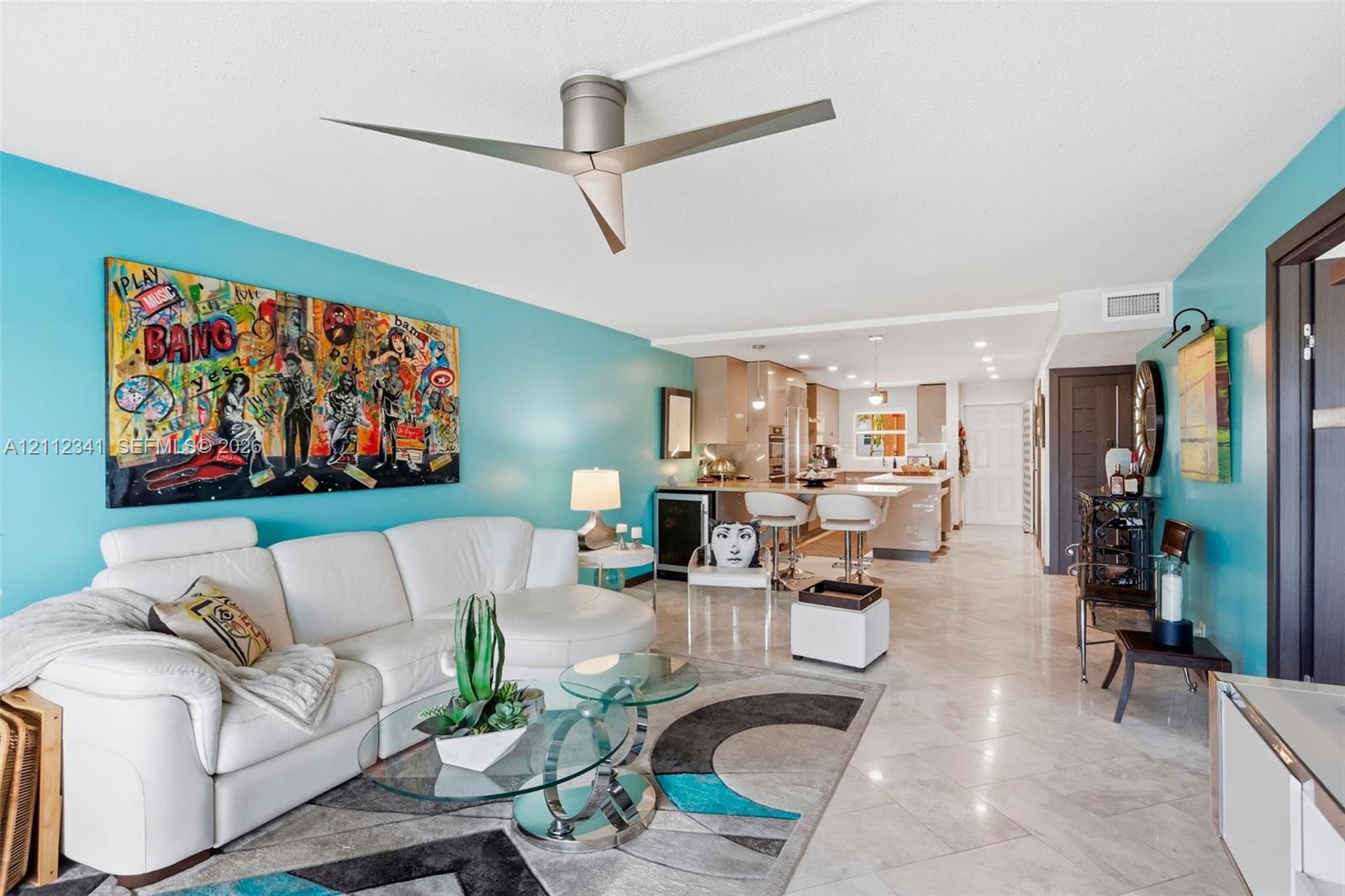 Open-concept living space featuring high-gloss tile flooring, a modern three-blade ceiling fan, and recessed lighting Open-concept living space featuring high-gloss tile flooring, a modern three-blade ceiling fan, and recessed lighting