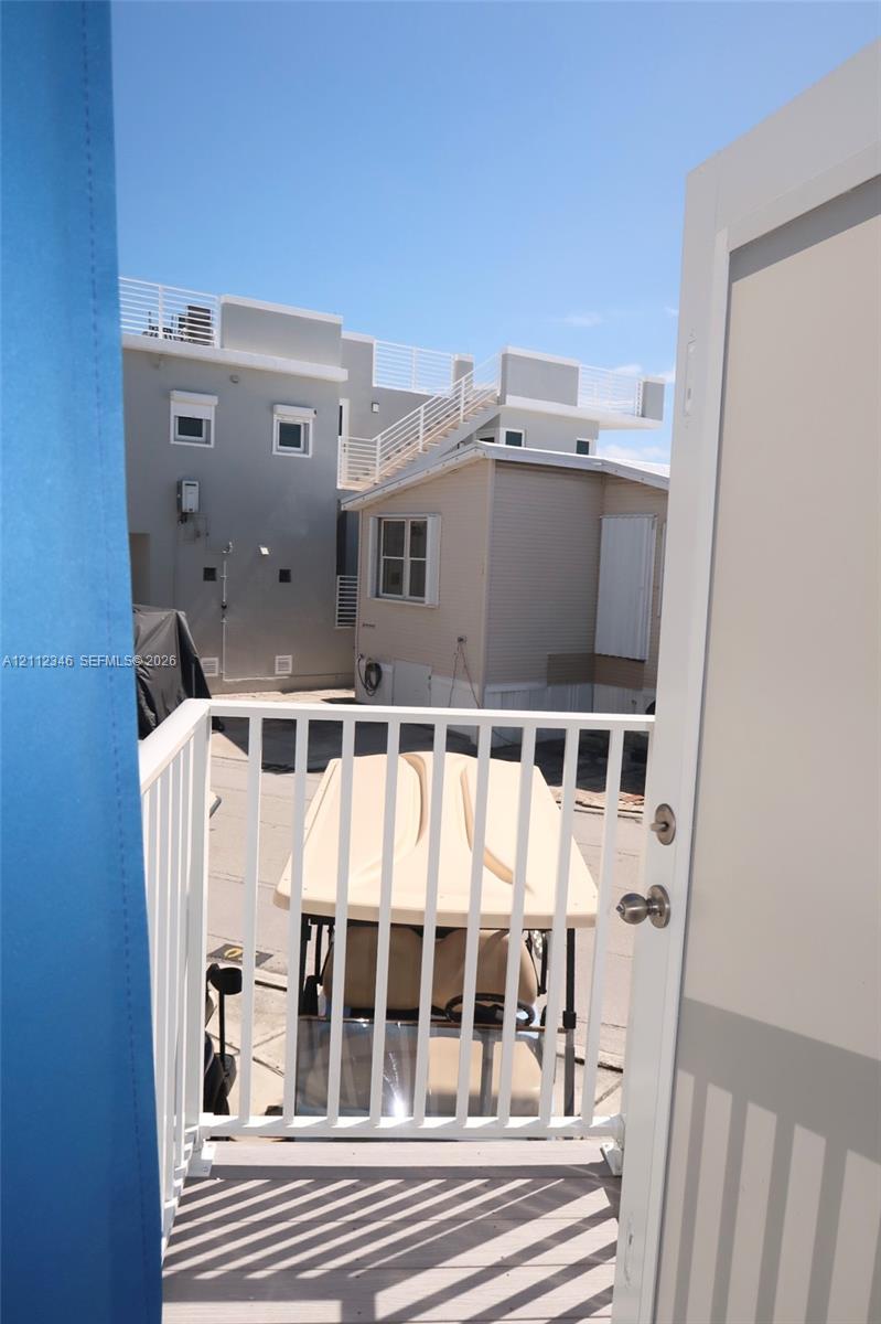 Elevated balcony featuring a white metal railing and composite decking