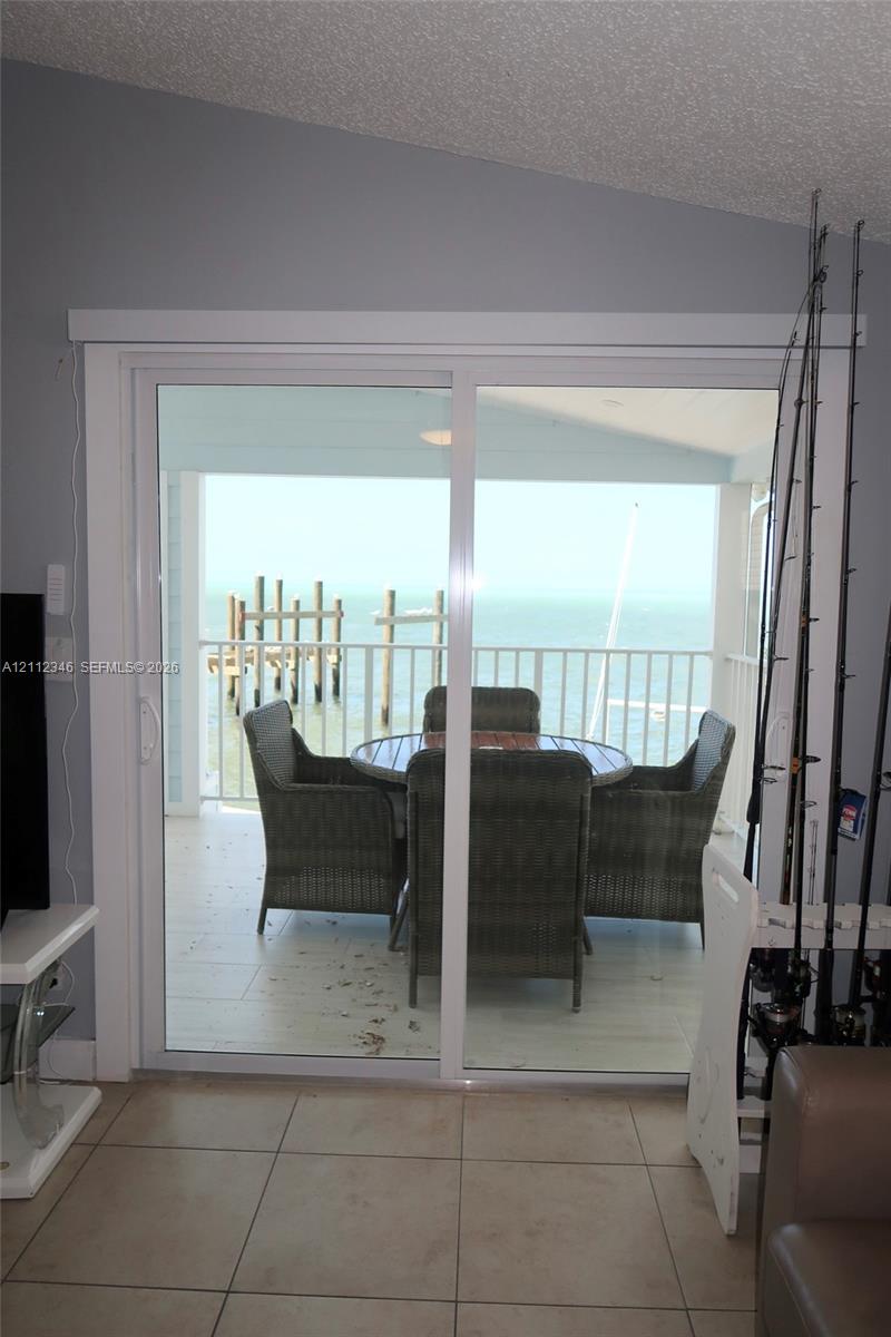 Dual white-framed double-hung windows with integrated roller shades and sand-finish exterior trim