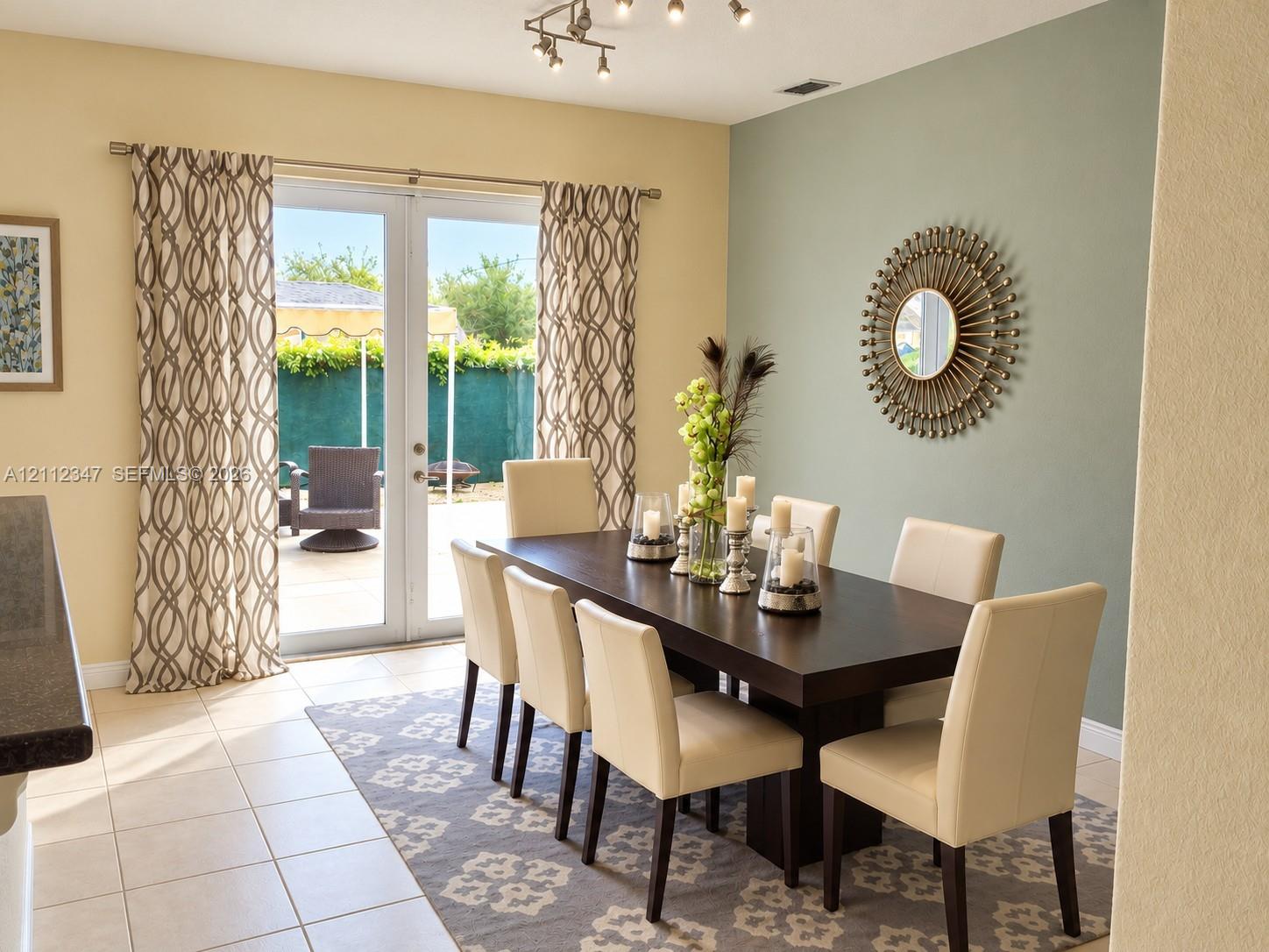 French doors featuring glass panels, ceramic tile flooring, and multi-directional track lighting