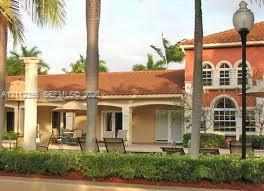 Stucco exterior featuring arched windows, a multi-paneled roof, covered outdoor loggia, and structural columns Stucco exterior featuring arched windows, a multi-paneled roof, covered outdoor loggia, and structural columns