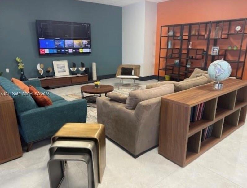 Dual-toned accent walls featuring deep teal and terracotta, large-format tile flooring, and a low-profile wood-finish media console