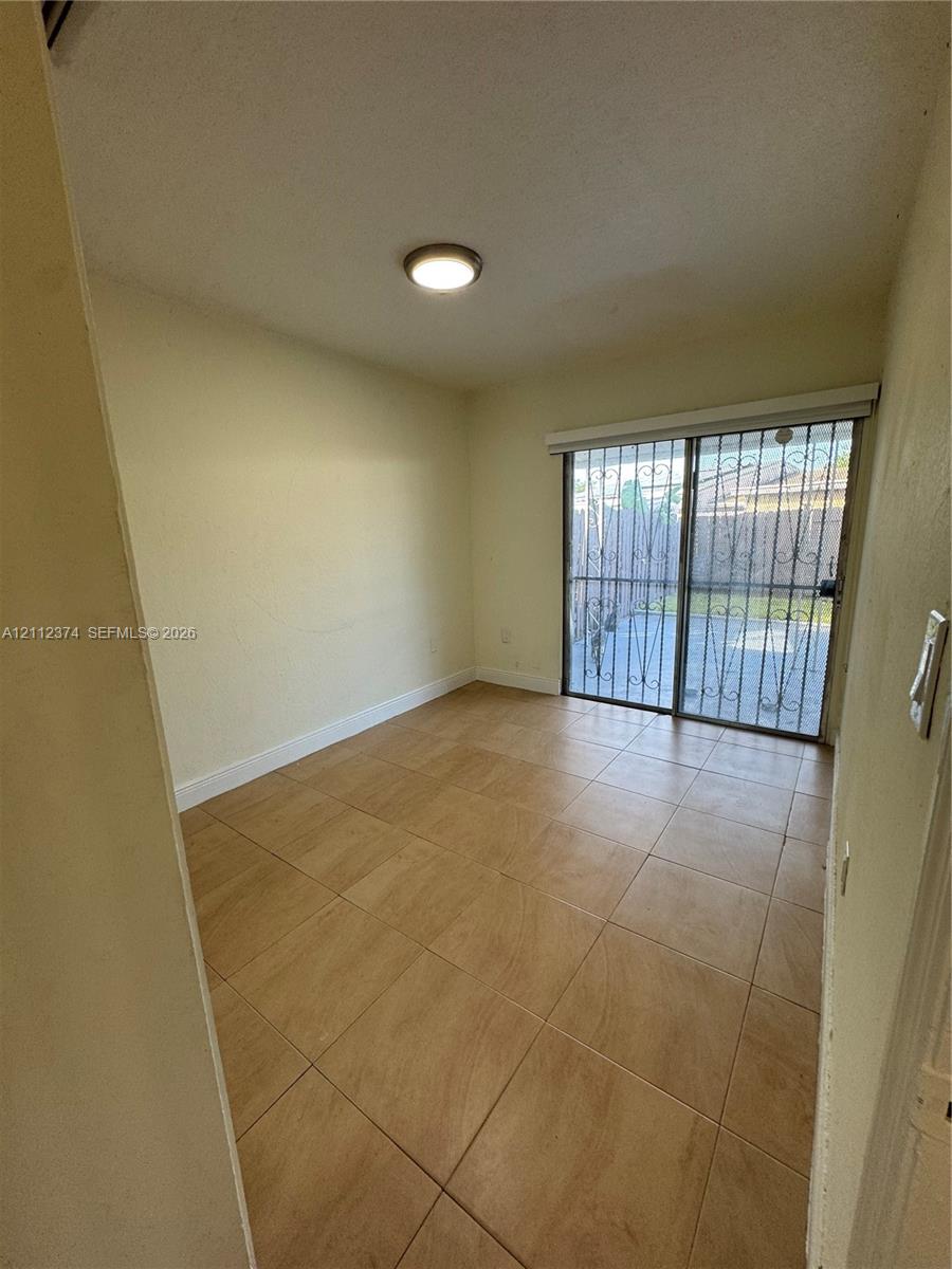 Bedroom Two with patio view