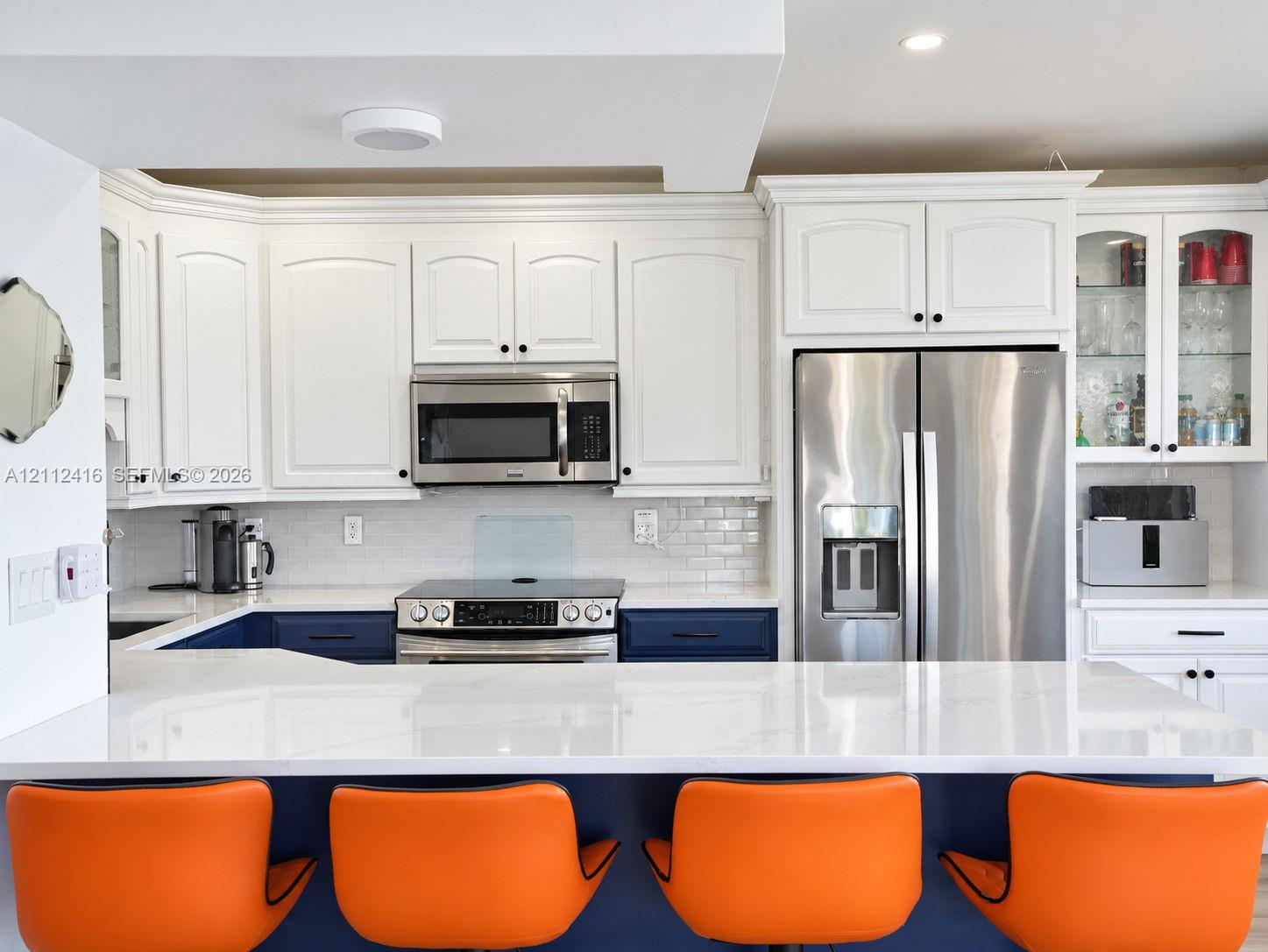 Updated Kitchen featuring new cabinetry, stainless steel appliances, and counter top dining. Updated Kitchen featuring new cabinetry, stainless steel appliances, and counter top dining.