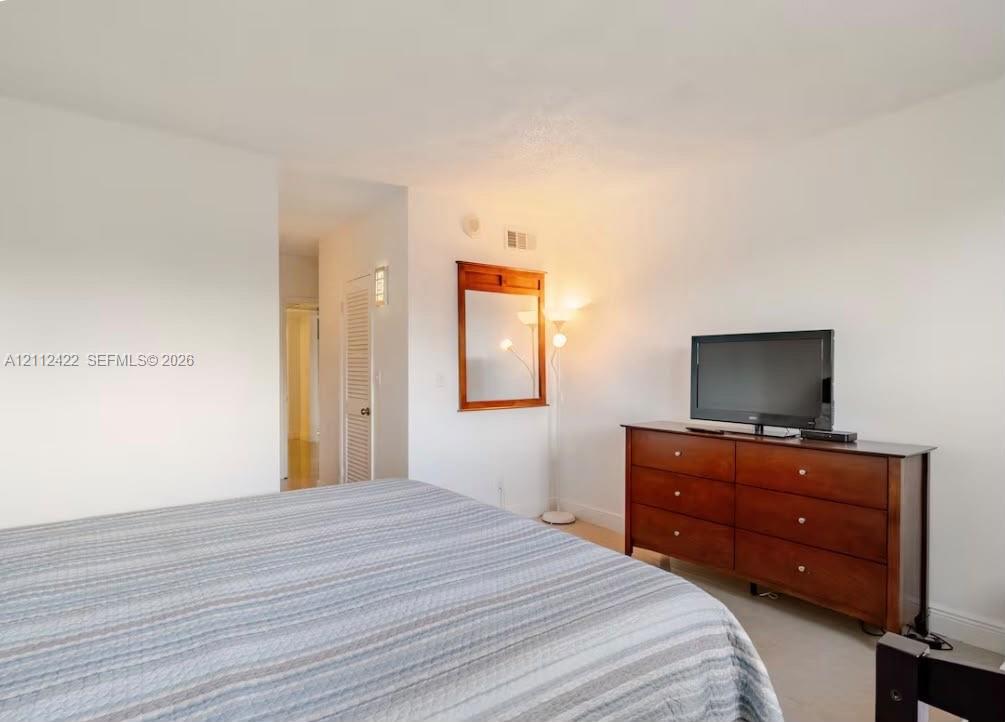 Wall-mounted wooden mirror and white-finished walls