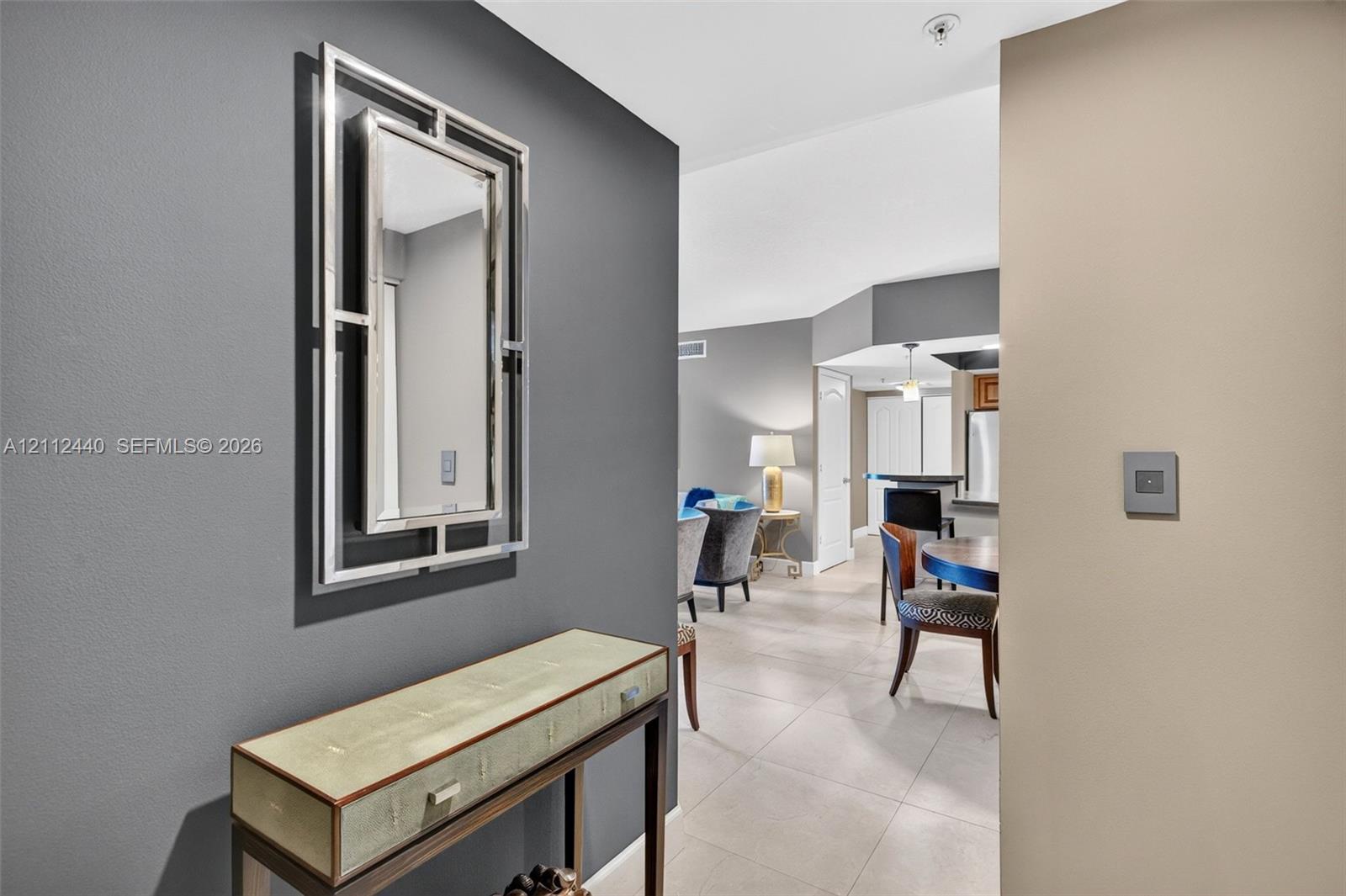 Designer selected paint on interior featuring high ceilings, minimalist grounted porcelain flooring, and accent-painted walls