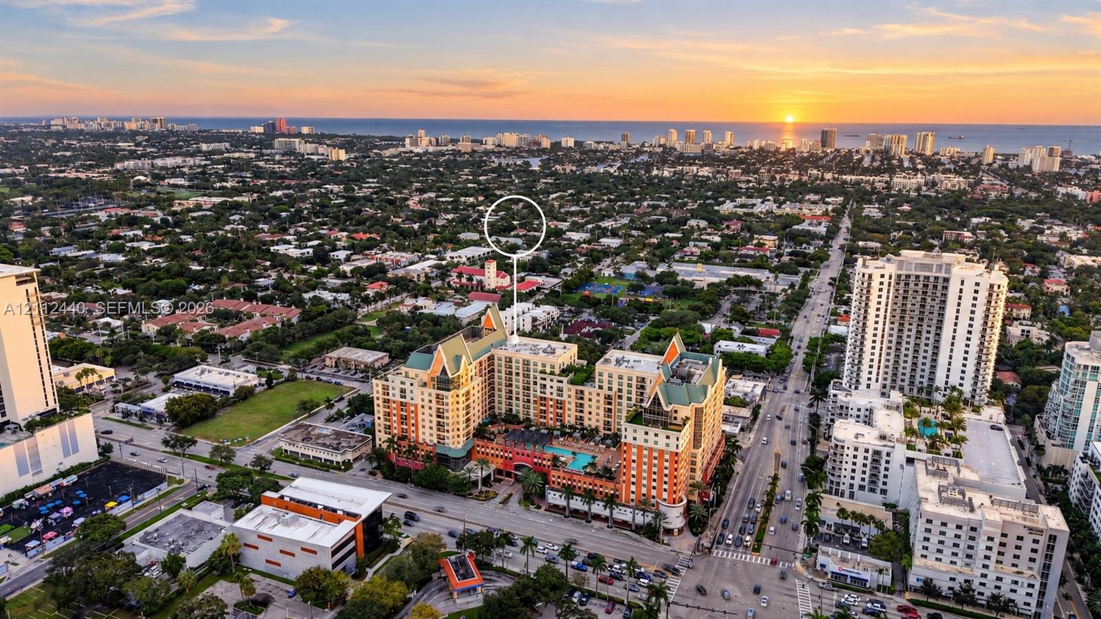 Aerial perspective of a multi-story residential building featuring a swimming pool, courtyard terrace, pitched roofline, and coastal horizon backdrop Aerial perspective of a multi-story residential building featuring a swimming pool, courtyard terrace, pitched roofline, and coastal horizon backdrop