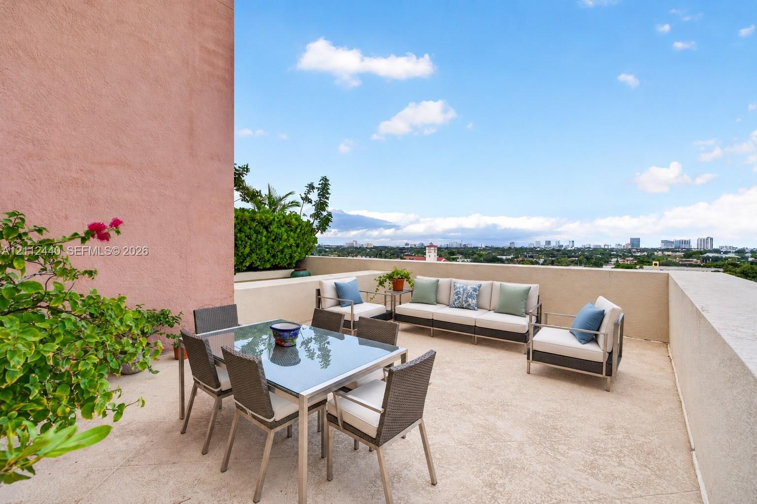 Open-air terrace featuring a textured concrete floor, solid masonry perimeter walls, and built-in landscape planters Open-air terrace featuring a textured concrete floor, solid masonry perimeter walls, and built-in landscape planters
