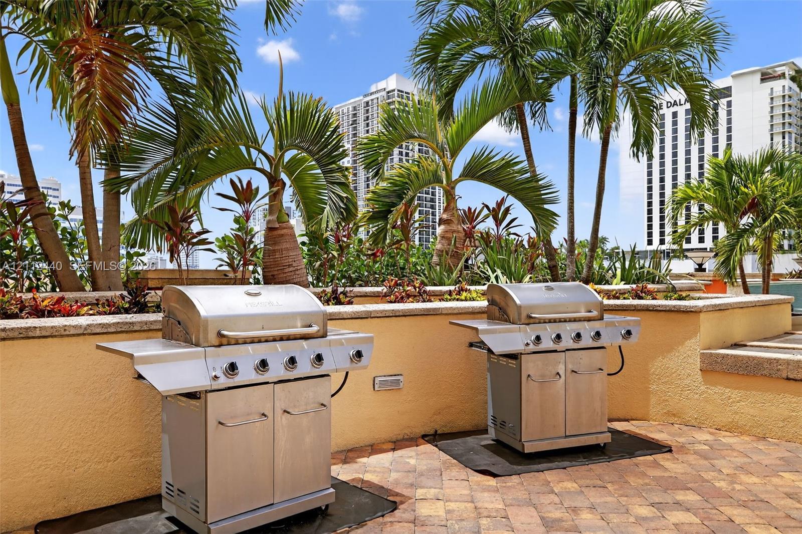 Outdoor terrace featuring two stainless steel gas grills