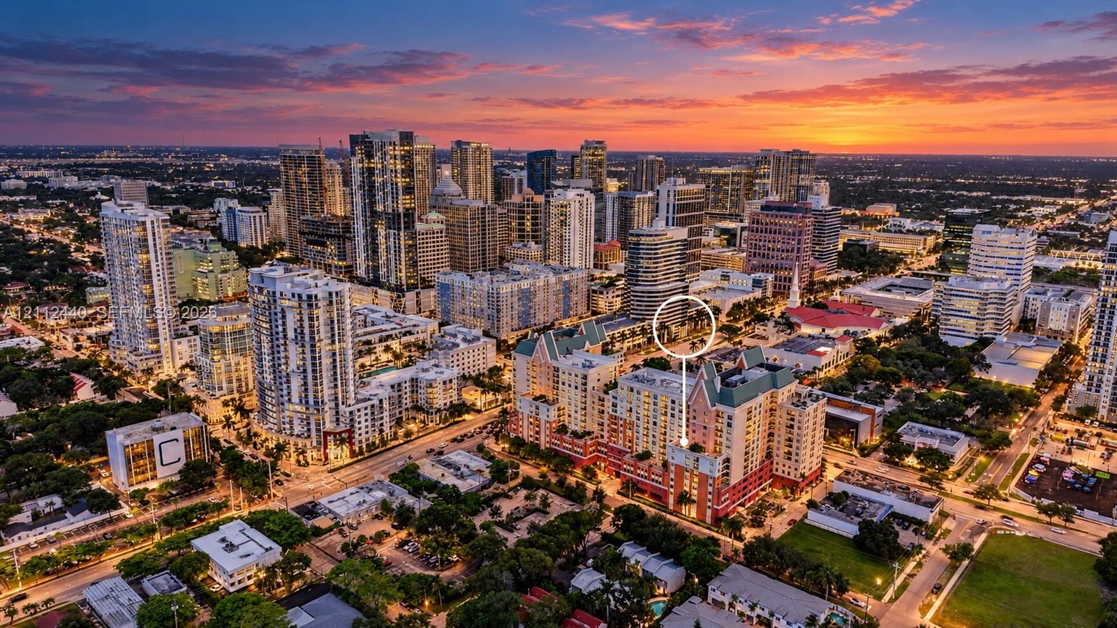 Aerial perspective of a multi-story building featuring a pitched green roof, balconies, and a terracotta-toned facade situated within a dense urban skyline Aerial perspective of a multi-story building featuring a pitched green roof, balconies, and a terracotta-toned facade situated within a dense urban skyline