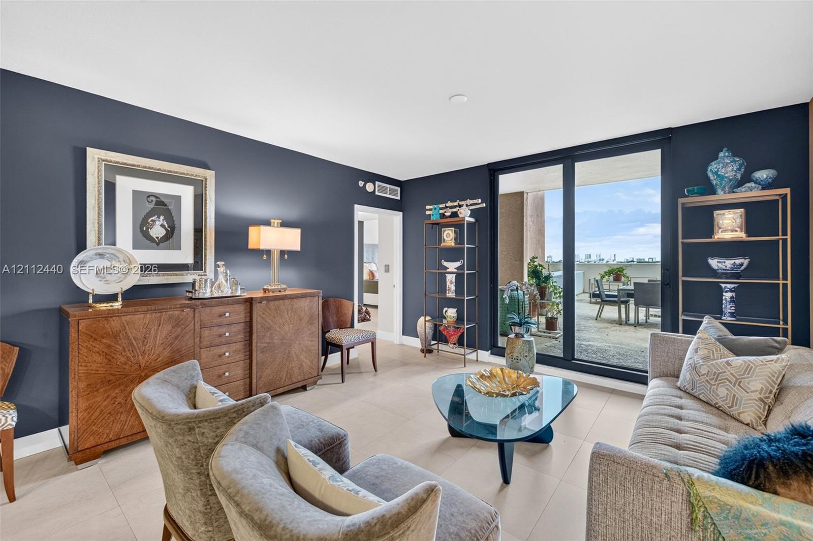 Living area featuring large-format porcelain flooring, floor-to-ceiling impact glass sliding doors, and a private OVERSIZED balcony Living area featuring large-format porcelain flooring, floor-to-ceiling impact glass sliding doors, and a private OVERSIZED balcony