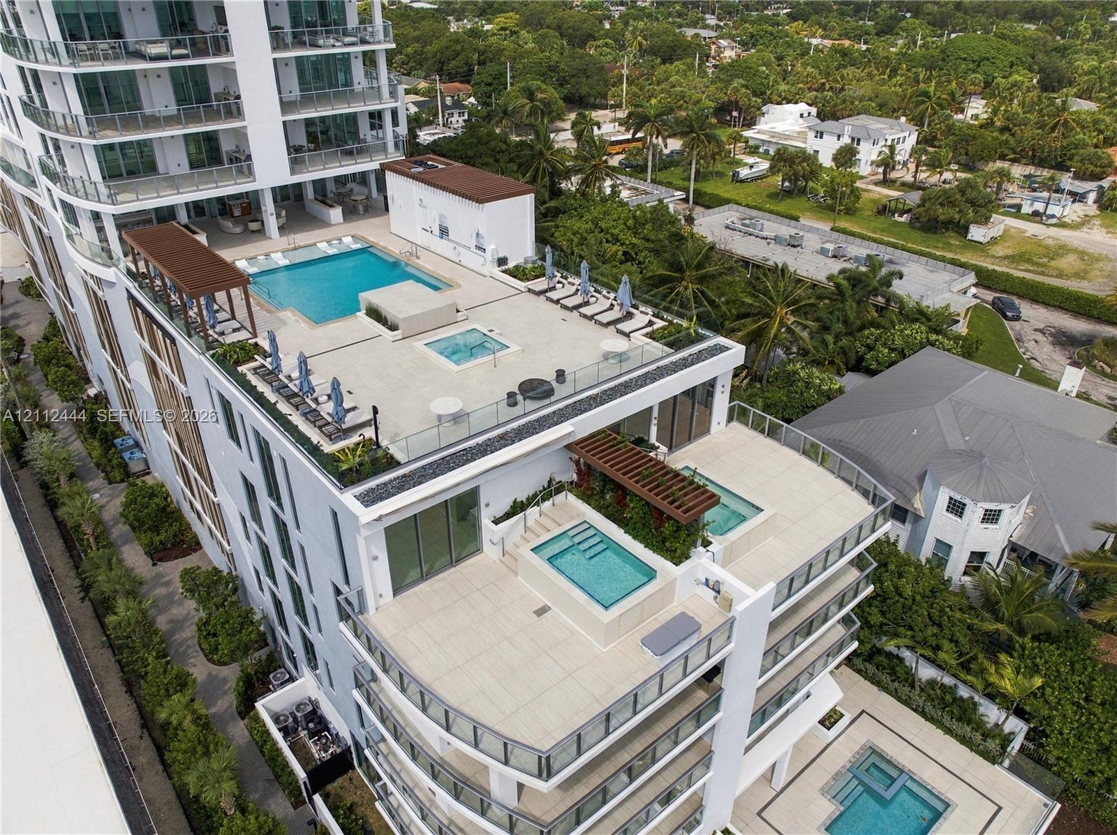 Multi-level terrace architecture featuring tiered swimming pools, integrated spas, glass balustrades, and pergola-covered outdoor areas