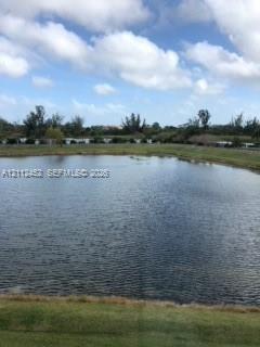 Natural pond featuring a perimeter of mature trees and expansive grass lawn Natural pond featuring a perimeter of mature trees and expansive grass lawn