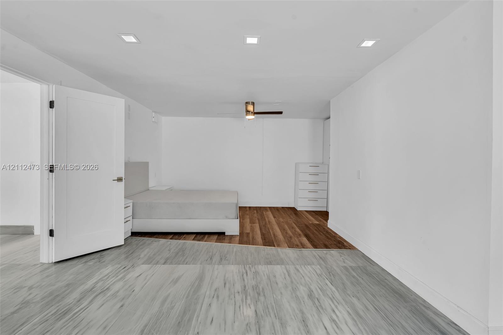 Interior space featuring recessed lighting, a ceiling fan, and distinct wood-finish flooring