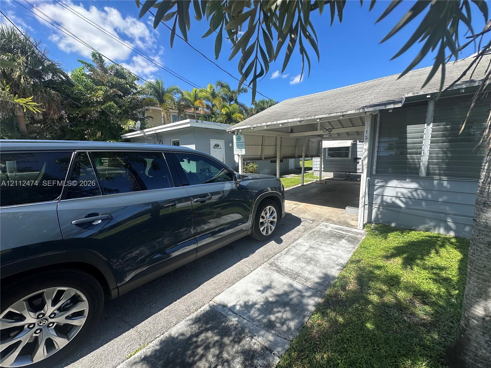 Exterior facade featuring a covered carport, concrete driveway, and lap siding Exterior facade featuring a covered carport, concrete driveway, and lap siding