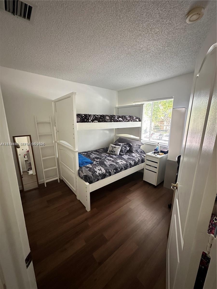 Room featuring wood-finish flooring and a window providing natural light