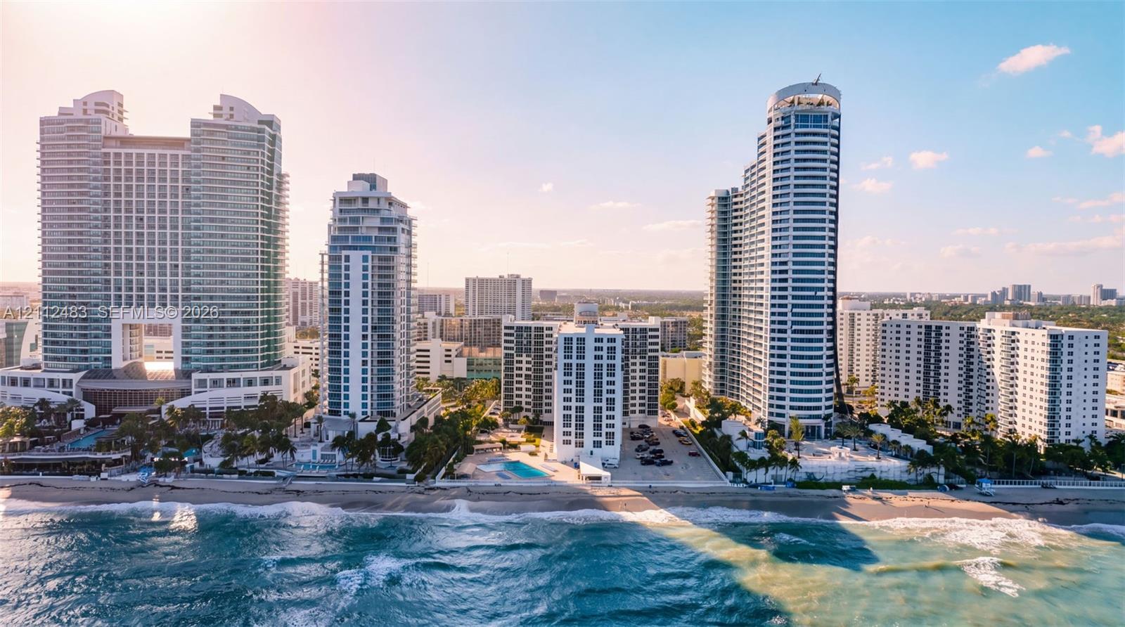 High-rise residential towers featuring direct oceanfront positioning, expansive coastal exposure, and private outdoor swimming pools
