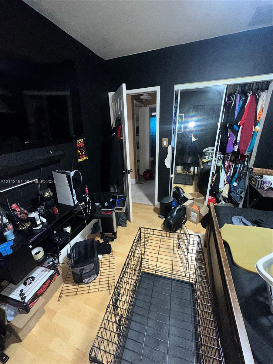 Wood-finish flooring and a built-in sliding-door mirrored closet